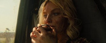 Movie still from “Texas Chainsaw Massacre” (2022), directed by David Blue Garcia – A woman with blood all over her face holding a cell phone; Close Up shot, High angle