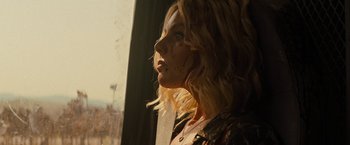 Movie still from “Texas Chainsaw Massacre” (2022), directed by David Blue Garcia – A woman looking out of a window at the sunset; Close Up shot, Low angle