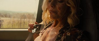 Movie still from “Texas Chainsaw Massacre” (2022), directed by David Blue Garcia – A woman with a knife in her mouth; Close Up shot, High angle