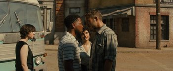 Movie still from “Texas Chainsaw Massacre” (2022), directed by David Blue Garcia – Two men and a woman standing next to each other on the street; Medium shot, Over the shoulder angle