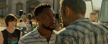 Movie still from “Texas Chainsaw Massacre” (2022), directed by David Blue Garcia – Two men talking to each other in front of a building; Close Up shot, Over the shoulder angle