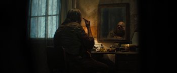 Movie still from “Texas Chainsaw Massacre” (2022), directed by David Blue Garcia – An older man sitting in front of a mirror; Medium shot, Over the shoulder angle