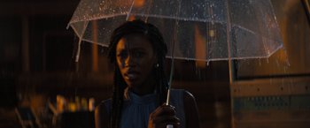 Movie still from “Texas Chainsaw Massacre” (2022), directed by David Blue Garcia – A woman holding an umbrella in the rain; Close Up shot, Over the shoulder angle