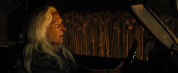 Movie still from “Texas Chainsaw Massacre” (2022), directed by David Blue Garcia – A man sitting in front of a fire place; Close Up shot, Over the shoulder angle