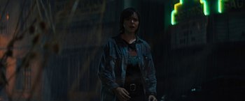 Movie still from “Texas Chainsaw Massacre” (2022), directed by David Blue Garcia – A person standing in the dark wearing a jacket; Medium shot, Over the shoulder angle