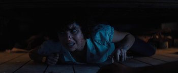 Movie still from “Texas Chainsaw Massacre” (2022), directed by David Blue Garcia – A woman with blood on her face is laying on the ground; Close Up shot, Overhead angle