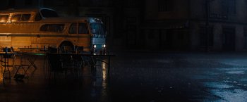 Movie still from “Texas Chainsaw Massacre” (2022), directed by David Blue Garcia – A bus driving down a street in the dark at night; Extreme Wide shot, High angle