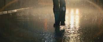 Movie still from “Texas Chainsaw Massacre” (2022), directed by David Blue Garcia – A person standing in a puddle of water on a wet street; Wide shot, Low angle