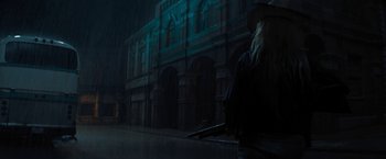 Movie still from “Texas Chainsaw Massacre” (2022), directed by David Blue Garcia – A person holding a gun in the rain; Wide shot, Low angle