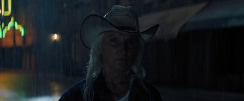 Movie still from “Texas Chainsaw Massacre” (2022), directed by David Blue Garcia – An older woman wearing a cowboy hat in the dark; Close Up shot, Low angle