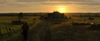 Movie still from “Texas Chainsaw Massacre” (2022), directed by David Blue Garcia – An old farm house in the middle of the sunset; Extreme Wide shot, Low angle