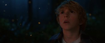 Movie still from “The Adam Project” (2022), directed by Shawn Levy – A young boy is looking up at the sky at night; Close Up shot, Low angle