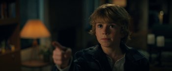 Movie still from “The Adam Project” (2022), directed by Shawn Levy – A young boy is pointing at the camera; Close Up shot, Over the shoulder angle
