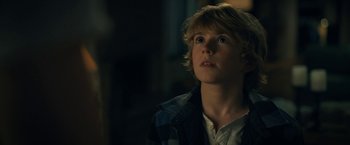 Movie still from “The Adam Project” (2022), directed by Shawn Levy – A young boy is looking up at the sky; Close Up shot, Over the shoulder angle