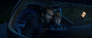 Movie still from “The Adam Project” (2022), directed by Shawn Levy – A man and a boy looking at something in a mirror; Close Up shot, Over the shoulder angle