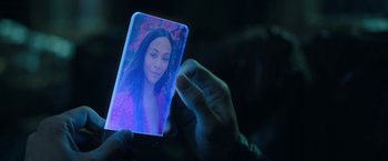 Movie still from “The Adam Project” (2022), directed by Shawn Levy – A person holding a cell phone in front of their face; Extreme Close Up shot, High angle