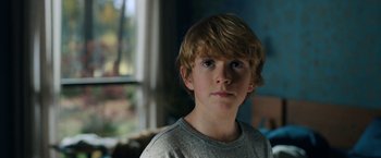 Movie still from “The Adam Project” (2022), directed by Shawn Levy – A young boy is looking into the camera; Close Up shot, Over the shoulder angle