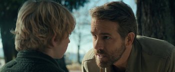 Movie still from “The Adam Project” (2022), directed by Shawn Levy – A man and a boy are talking to each other; Close Up shot, Over the shoulder angle