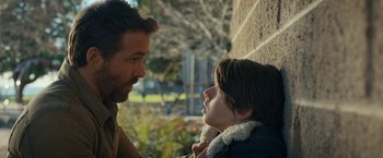 Movie still from “The Adam Project” (2022), directed by Shawn Levy – A man and a child looking at one another; Close Up shot, Over the shoulder angle