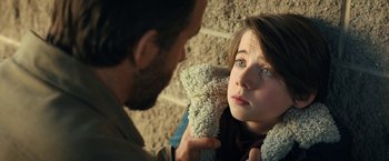 Movie still from “The Adam Project” (2022), directed by Shawn Levy – A man holding a teddy bear in front of a woman; Close Up shot, Over the shoulder angle