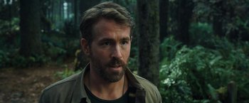 Movie still from “The Adam Project” (2022), directed by Shawn Levy – A person with a beard in the woods; Close Up shot, Over the shoulder angle