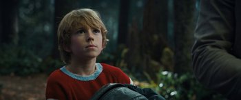 Movie still from “The Adam Project” (2022), directed by Shawn Levy – A boy with a backpack looking up at the sky; Close Up shot, Low angle