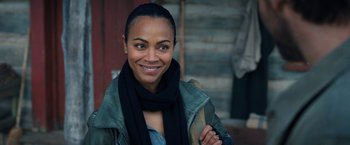 Movie still from “The Adam Project” (2022), directed by Shawn Levy – A woman wearing a jacket and scarf smiling for the camera; Close Up shot, Over the shoulder angle