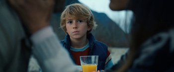 Movie still from “The Adam Project” (2022), directed by Shawn Levy – A young boy holding a glass of orange juice; Close Up shot, Over the shoulder angle