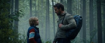 Movie still from “The Adam Project” (2022), directed by Shawn Levy – A man and a boy in the woods talking to each other; Medium shot, Over the shoulder angle