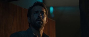 Movie still from “The Adam Project” (2022), directed by Shawn Levy – A person with a beard looking up; Close Up shot, Low angle