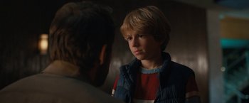 Movie still from “The Adam Project” (2022), directed by Shawn Levy – A young boy in a red and white shirt is looking at a man in a blue and white jacket; Close Up shot, Over the shoulder angle
