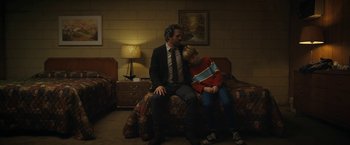 Movie still from “The Adam Project” (2022), directed by Shawn Levy – A man sitting on a bed next to a woman; Medium shot, Over the shoulder angle