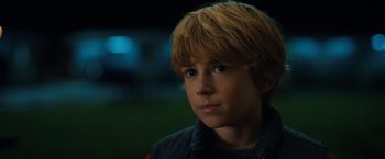 Movie still from “The Adam Project” (2022), directed by Shawn Levy – A young boy with blonde hair stares into the distance; Close Up shot, High angle