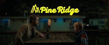 Movie still from “The Adam Project” (2022), directed by Shawn Levy – A man and a boy sitting at a table with a beer; Medium shot, Over the shoulder angle