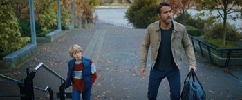 Movie still from “The Adam Project” (2022), directed by Shawn Levy – A man and a boy walking down a street; Medium shot, Over the shoulder angle