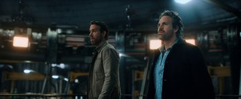 Movie still from “The Adam Project” (2022), directed by Shawn Levy – A couple of men standing next to each other; Medium shot, Low angle