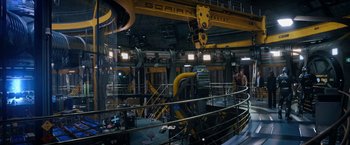 Movie still from “The Adam Project” (2022), directed by Shawn Levy – A man standing inside of a building next to a crane; Extreme Wide shot, High angle