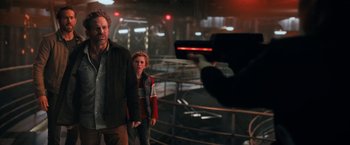 Movie still from “The Adam Project” (2022), directed by Shawn Levy – A man taking a picture of a man and a boy; Medium shot, Over the shoulder angle