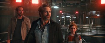 Movie still from “The Adam Project” (2022), directed by Shawn Levy – A man standing next to a woman in a dark room; Medium shot, Over the shoulder angle