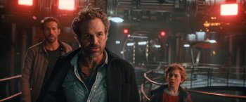 Movie still from “The Adam Project” (2022), directed by Shawn Levy – A man standing next to a woman in a dark room; Close Up shot, Over the shoulder angle