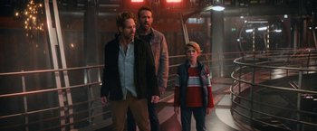 Movie still from “The Adam Project” (2022), directed by Shawn Levy – Two men and a boy standing next to each other; Medium shot, Over the shoulder angle