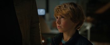 Movie still from “The Adam Project” (2022), directed by Shawn Levy – A young boy looking up into the air; Close Up shot, Over the shoulder angle