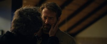 Movie still from “The Adam Project” (2022), directed by Shawn Levy – A person with his hand on his face; Close Up shot, Over the shoulder angle