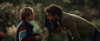 Movie still from “The Adam Project” (2022), directed by Shawn Levy – A man and a boy face each other in a forest; Close Up shot, Over the shoulder angle