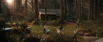 Movie still from “The Adam Project” (2022), directed by Shawn Levy – Two people are in the woods near a log cabin; Extreme Wide shot, High angle