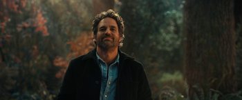 Movie still from “The Adam Project” (2022), directed by Shawn Levy – A man in a black jacket is smiling for the camera; Close Up shot, Over the shoulder angle