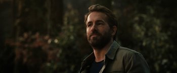 Movie still from “The Adam Project” (2022), directed by Shawn Levy – A man with a goatee is looking to his left; Close Up shot, Over the shoulder angle