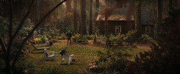 Movie still from “The Adam Project” (2022), directed by Shawn Levy – A man standing in front of a cabin in the woods; Extreme Wide shot, High angle