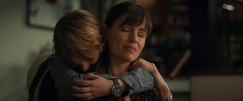 Movie still from “The Adam Project” (2022), directed by Shawn Levy – A man and a woman hugging each other in a room; Close Up shot, Over the shoulder angle