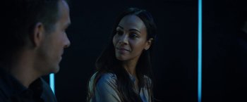 Movie still from “The Adam Project” (2022), directed by Shawn Levy – A woman with long black hair is posing for a picture; Close Up shot, Low angle